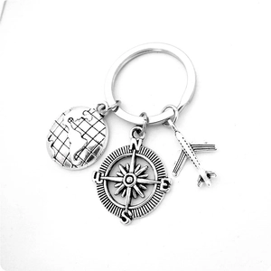 Travel keychain with earth globe, compass and airplane charms in silver finish
