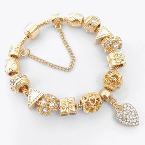 Gold-plated snake chain bracelet featuring crystal heart charms and gift box beads