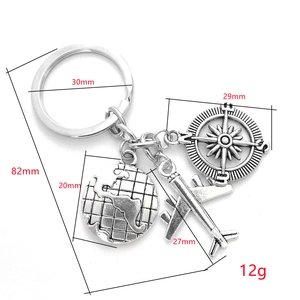 Detailed view of travel keychain with globe, airplane, and compass charms with dimensions