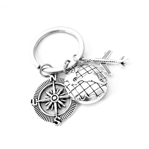 Silver travel keychain with globe, airplane, and compass pendants for graduation gift