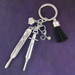 Silver medical keychain with nurse hat, stethoscope, syringe pendants and black tassel