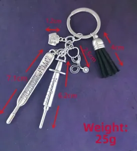 Detailed view of medical charms keychain with syringe and thermometer charms