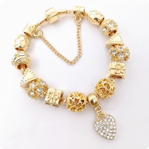 Golden snake chain charm bracelet with hollow heart beads and sparkling diamond heart pendant