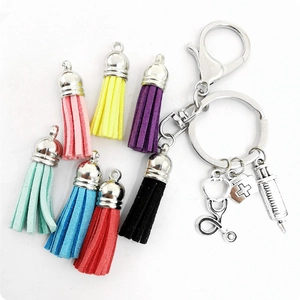 Close-up of medical themed keychain charms with colorful tassels and silver alloy pendants