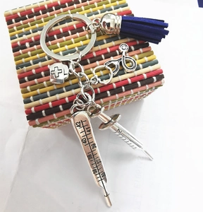 Detailed medical themed keychain featuring silver stethoscope, syringe and blue tassel