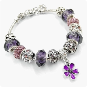 Silver snake chain bracelet with purple crystal beads and a four-leaf clover flower charm