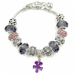 Detailed macro of silver snake chain bracelet with purple crystal beads and flower charm