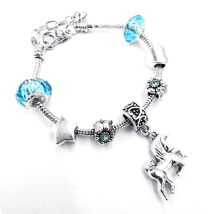 Silver unicorn charm bracelet with light blue crystal beads on a snake chain