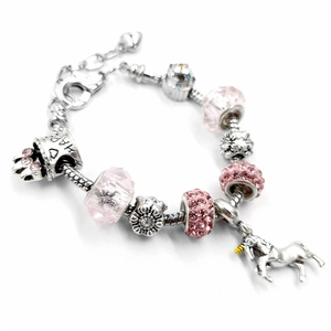 Silver snake chain bracelet with pink crystal beads and unicorn charm on white background