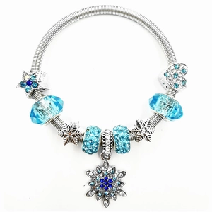 Detail of Christmas snowflake bracelet with blue crystal beads and silver star charms