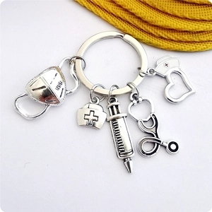 Silver alloy medical keychain featuring N95 mask, stethoscope, and nurse hat charms
