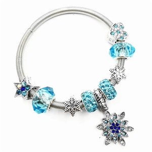 Silver beaded bracelet with blue snowflakes, crystal stars and stretchy metal band