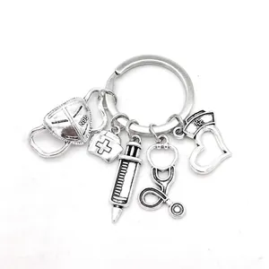 Silver medical keychain with syringe, stethoscope, mask and nurse hat charms weight 10g