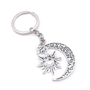 Silver celestial keychain with hollow moon and sun pendant in vintage metal style
