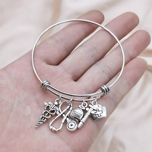 Silver stainless steel medical charm bracelet with stethoscope and nurse hat pendants