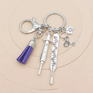 Medical theme keychain with silver syringe, thermometer, stethoscope and purple tassel