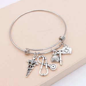 Silver medical charm bangle featuring stethoscope, nurse hat and syringe charms for nurses