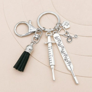Medical themed silver keychain with tassel syringe thermometer and stethoscope charms