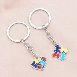 Polished autism awareness heart and puzzle piece enamel pendants on silver keychains