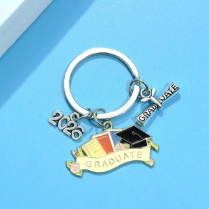 Silver 2026 graduation keychain featuring a doctoral cap, book, and graduate scroll charm