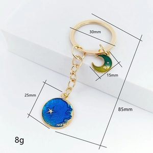 Golden star and moon keychain with blue star pendant and colorful crescent moon charm
