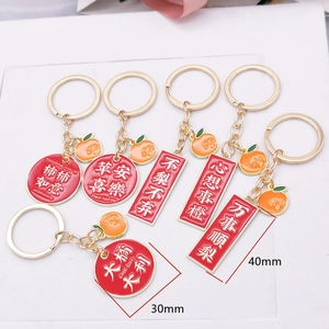 Detailed view of red enamel panda charms with gold alloy keyrings in 30mm and 40mm sizes