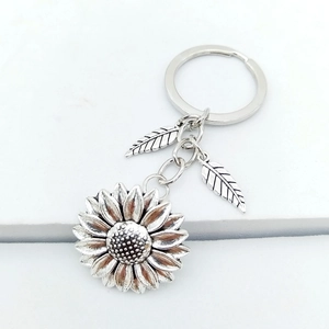 Close-up of vintage sunflower keychain with zinc alloy leaves and antique silver finish