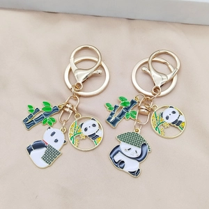 Golden panda keychain with bamboo charms and black white enamel panda pendants for bags