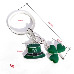 St. Patrick's Day keychain featuring green enamel shamrock and leprechaun hat pendants