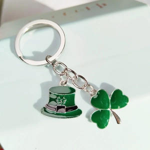 St. Patrick's Day keychain featuring a green clover and a leprechaun hat charm