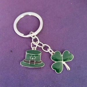 Macro view of St. Patrick's Day keychain with green hat and shamrock enamel pendants