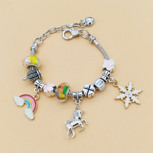 DIY charm bracelet with unicorn, rainbow pendants and pink floral beads on silver chain