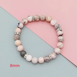 Close-up of 8mm pink zebra jasper beads with sparkling diamond-encrusted silver spacers