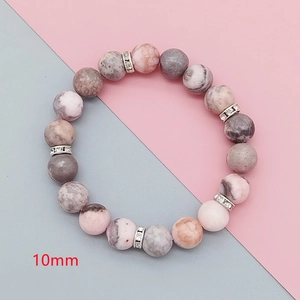 Macro shot of 10mm pink zebra stone beads with silver crystal spacers on bracelet