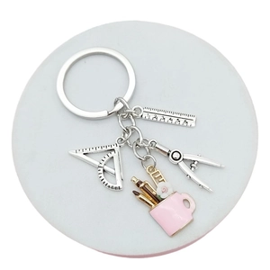 Creative stationery keychain with silver ruler, compass, and pink pen holder pendant
