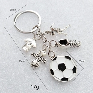 Detailed view of soccer keychain featuring football jersey shoe and heart charm pendants