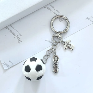 Soccer keychain featuring a mini football, metallic cleat, and SOCCER jersey pendant