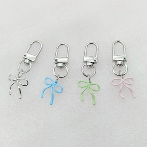 Detailed view of alloy bowknot charms in silver, blue, green, and pink colors