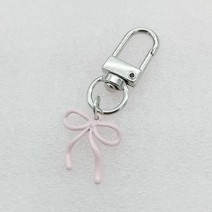 Pink bow keychain accessory with silver metal lobster clasp for bags and phones