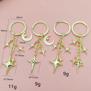 Set of four gold metal star and moon pendants keychain charms for bags and accessories