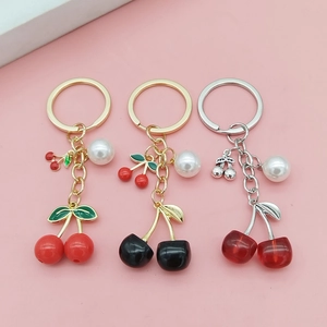 Creative cherry fruit keychain with pearls in red, black, and dark red colors