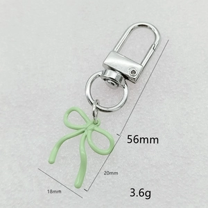 Light green painted enamel bow keychain with silver lobster clasp and size dimensions