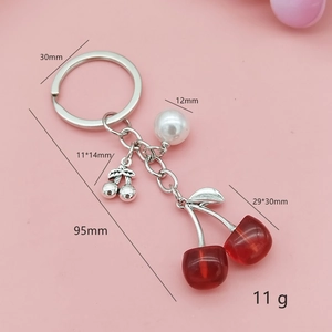 Creative cherry keychain with red resin fruit, white pearl, and silver metal ring