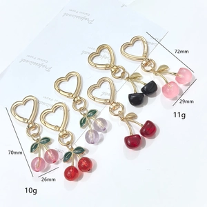 Detailed view of cherry keychains with dimensions and gold heart-shaped hooks