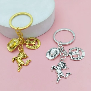 Western cowboy keychain set with horse, hat, and horseshoe charms in gold and silver finish