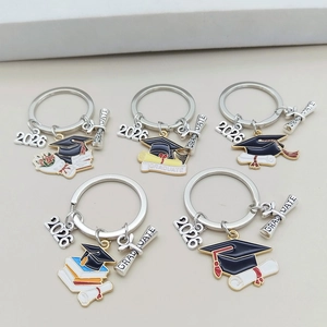 Detailed set of 5 graduation keychains featuring 2026 charms and black doctor hat pendants