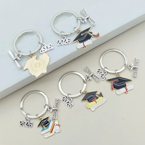 Detailed close-up of five 2026 graduation keychains with caps and scrolls charms