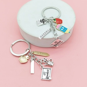 Teacher appreciation keychains with red apple, pencil, and ruler charms on display