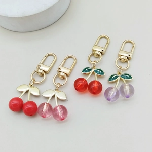 Creative acrylic cherry keychains in four colors with gold lobster clasps and leaf details