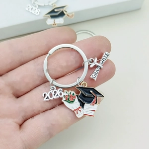 Detail of 2026 graduation keychain set with mortarboard, bouquet and scroll charms